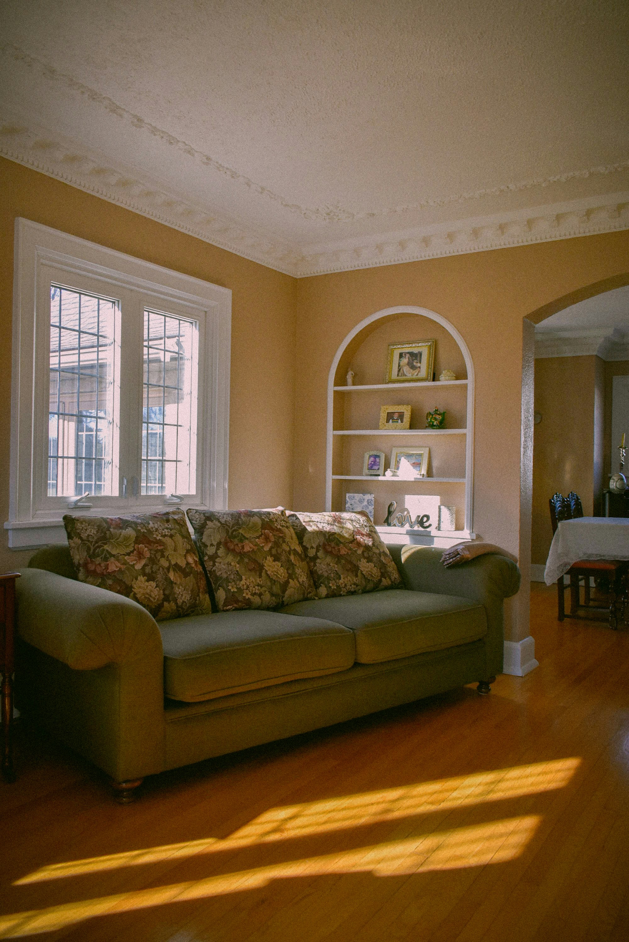 a living room with a couch and a book shelf