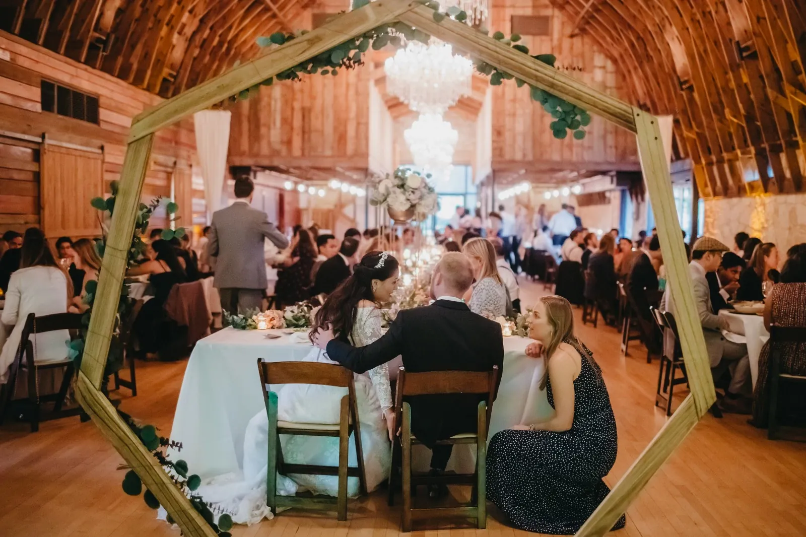 A couple in formal wedding attire embraces intimately in a vast.