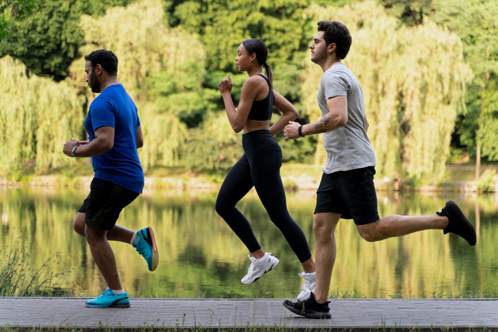 Group of friends running together for a marathon training.