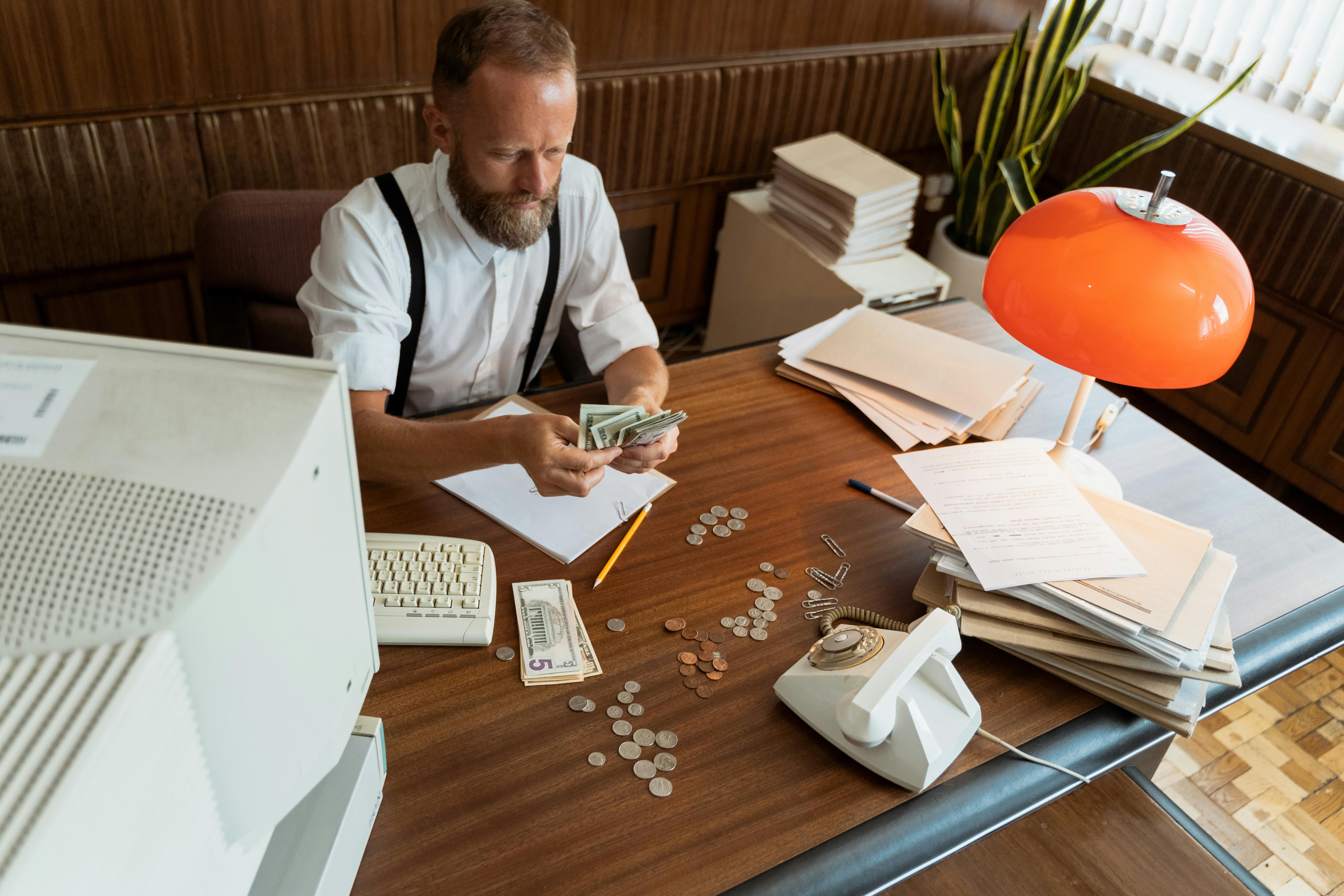 Man in a white shirt counting broker fees