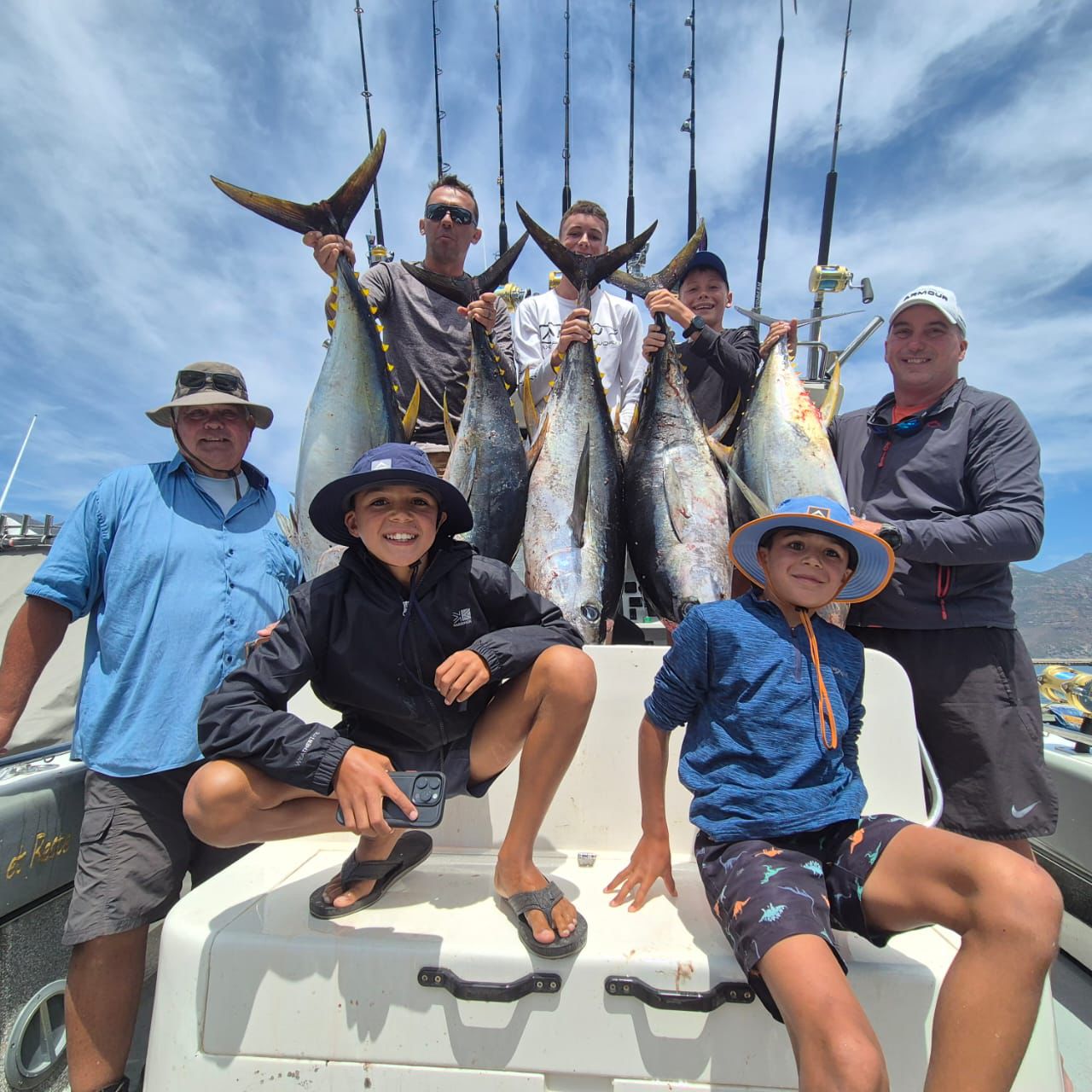 Fishermen celebrating a successful catch on a Salt Safari charter.