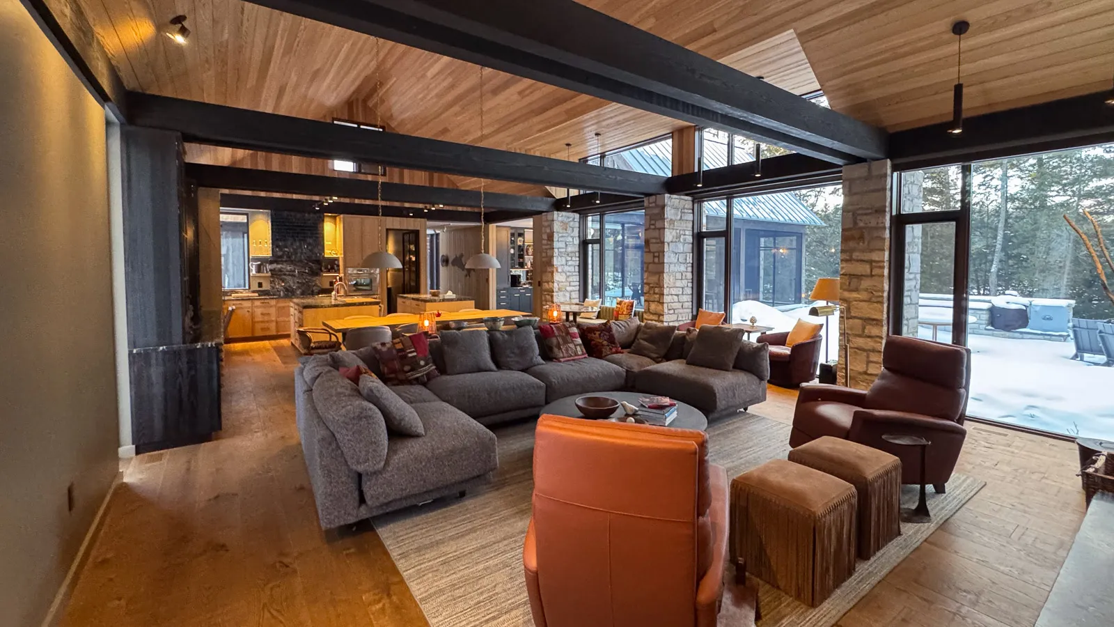 large great room with high end ranch style decor and exposed beams.