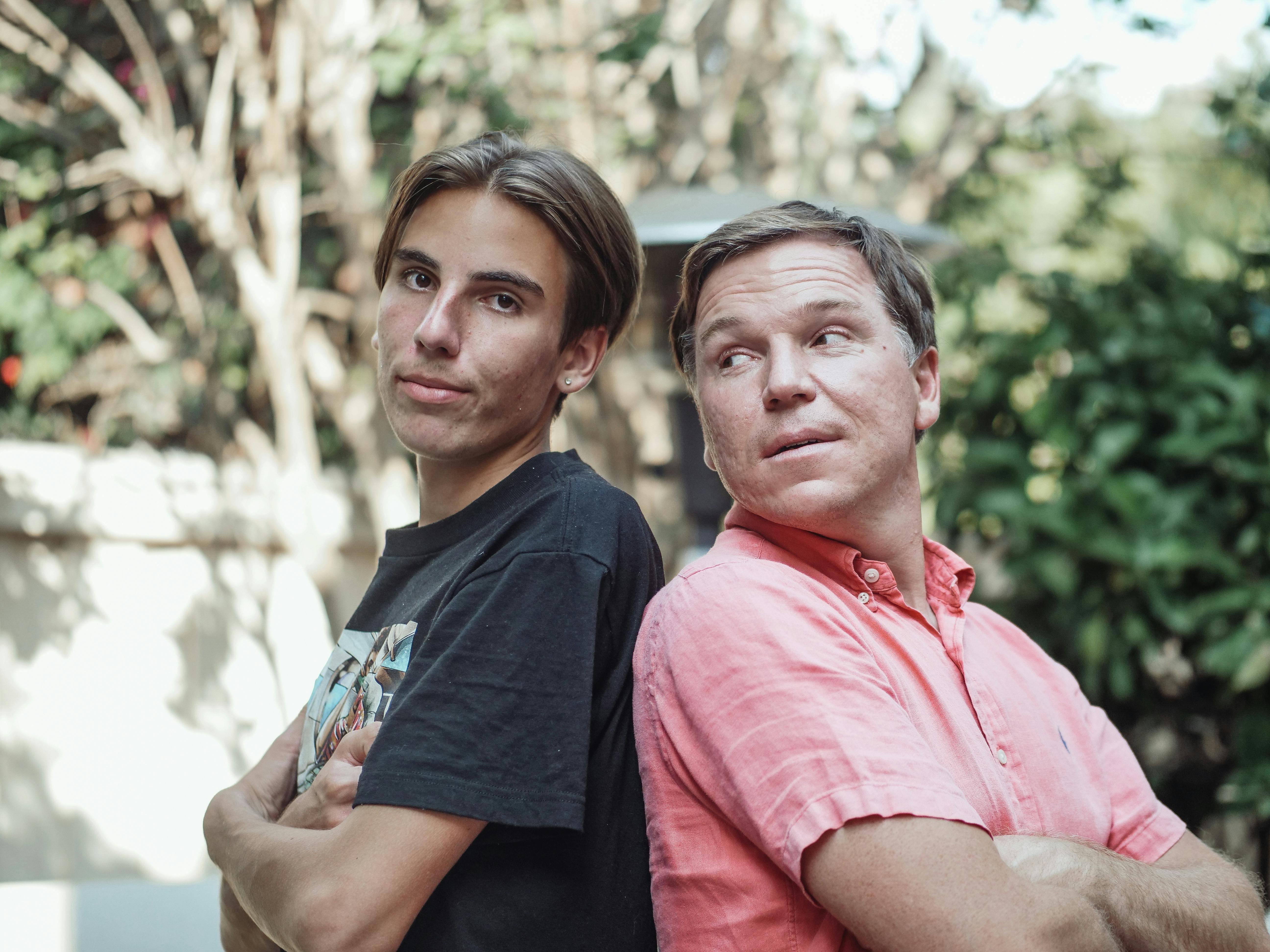 Conversion Truth for Families: A young person and their father standing back to back with arms crossed