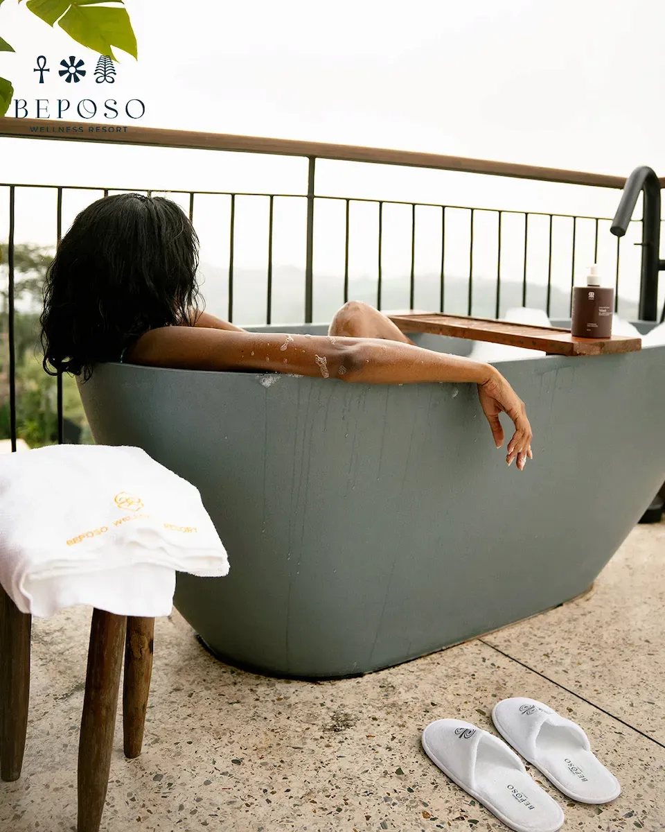 Woman relaxing in a tub on a balcony