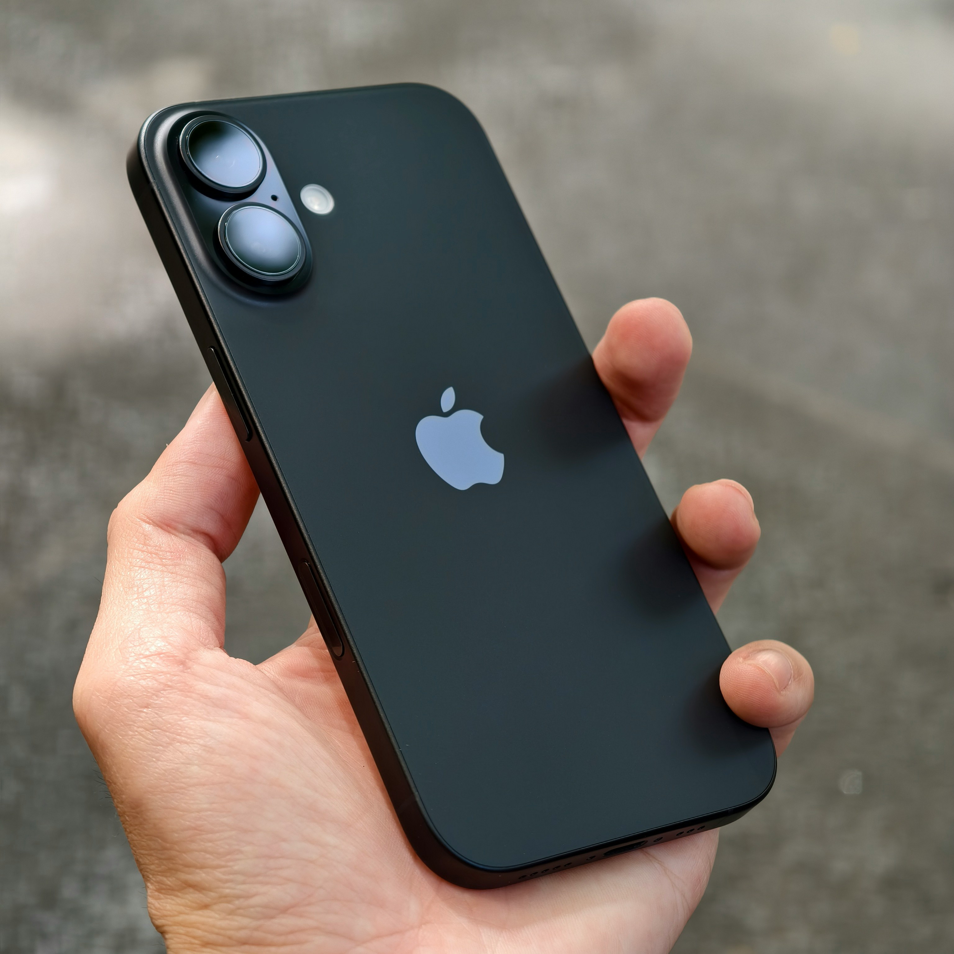 A person holding an iPhone in their hand
