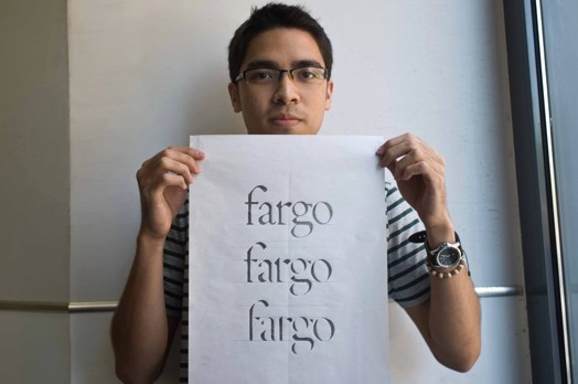 man with glasses holding paper