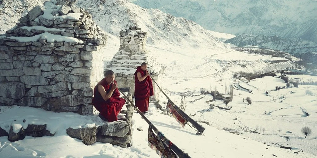 Monks in snowy landscape