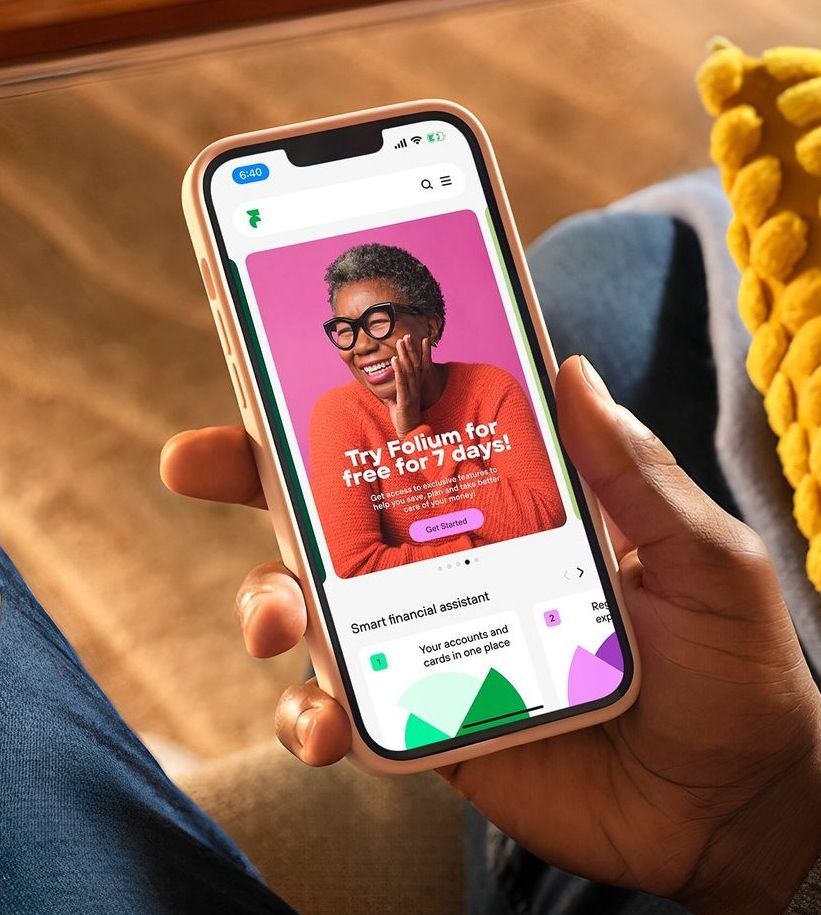 Close-up of a dark green leaf showing its textured surface and central vein against a muted background.