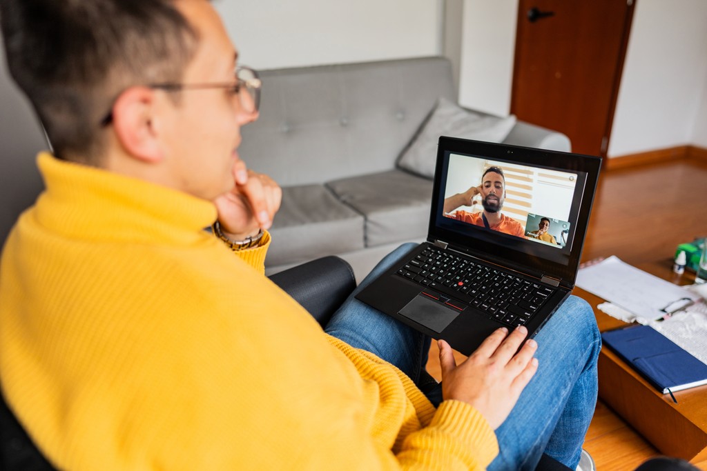 Young man talking to his manager via video call