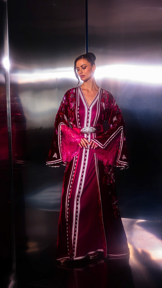 Fuchsia Moroccan caftan with sculptural sleeves and intricate embroidery, bold handcrafted couture piece in Bahrain