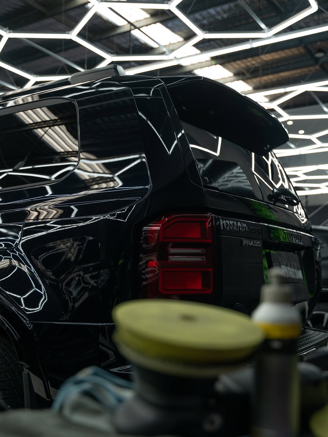 Black cosmetic product bottle against a dark background