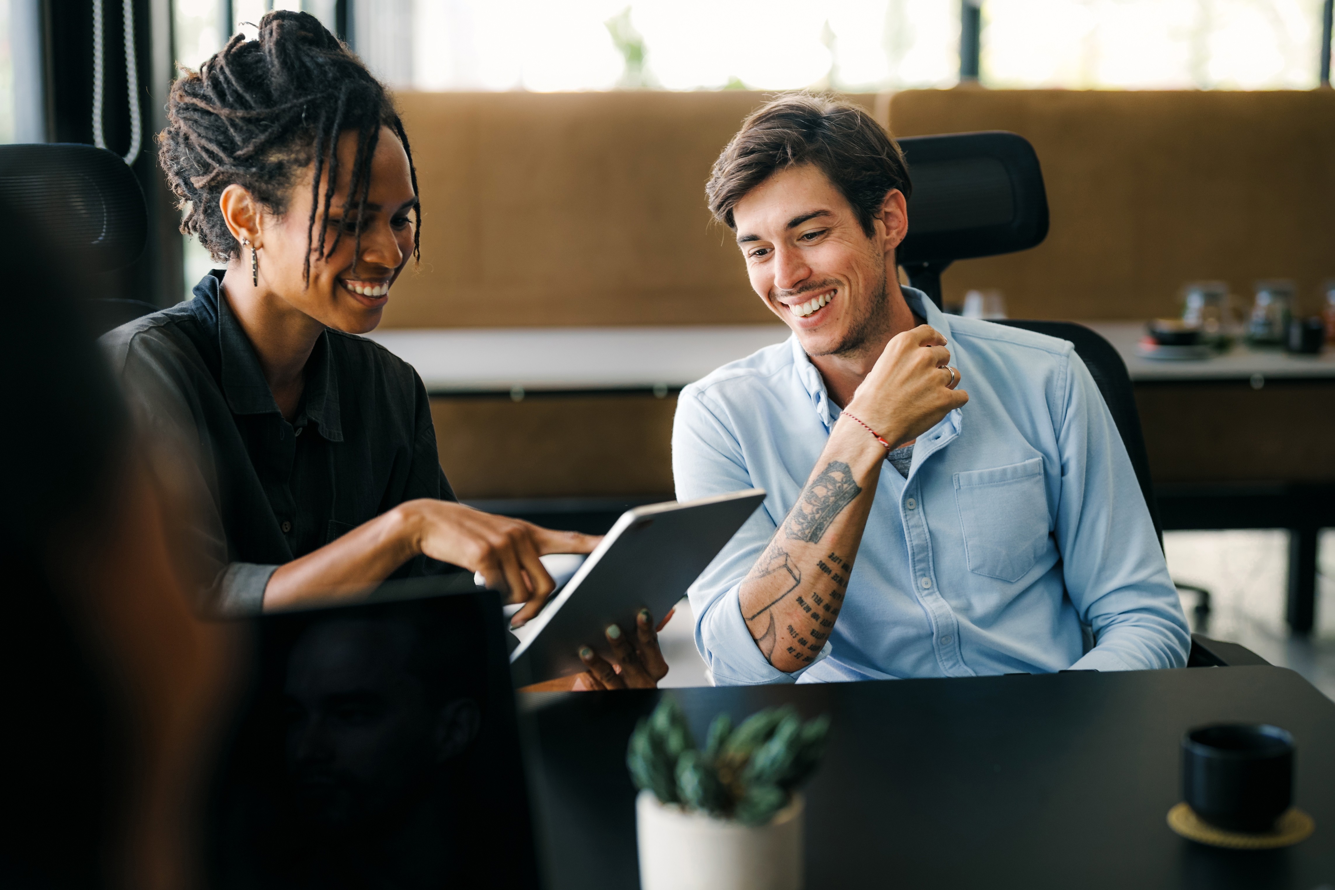 A maroon passport, a credit card, and a document are placed on a dark surface.