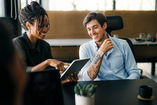 A maroon passport, a credit card, and a document are placed on a dark surface.