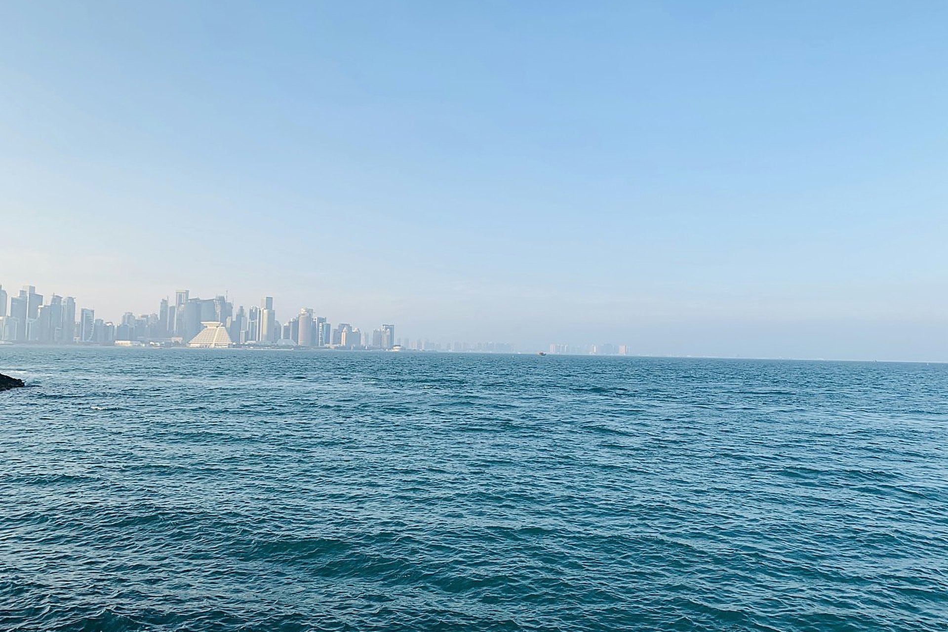 La mer bleue devant les tours de West Bay, à Doha, où l'on vit avec une heure d'avance sur Paris en été