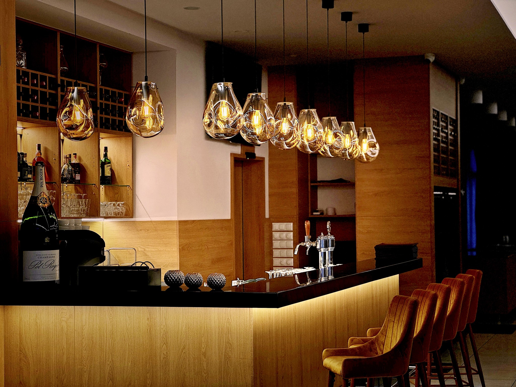 turned-on filament bulb lights at bar counter