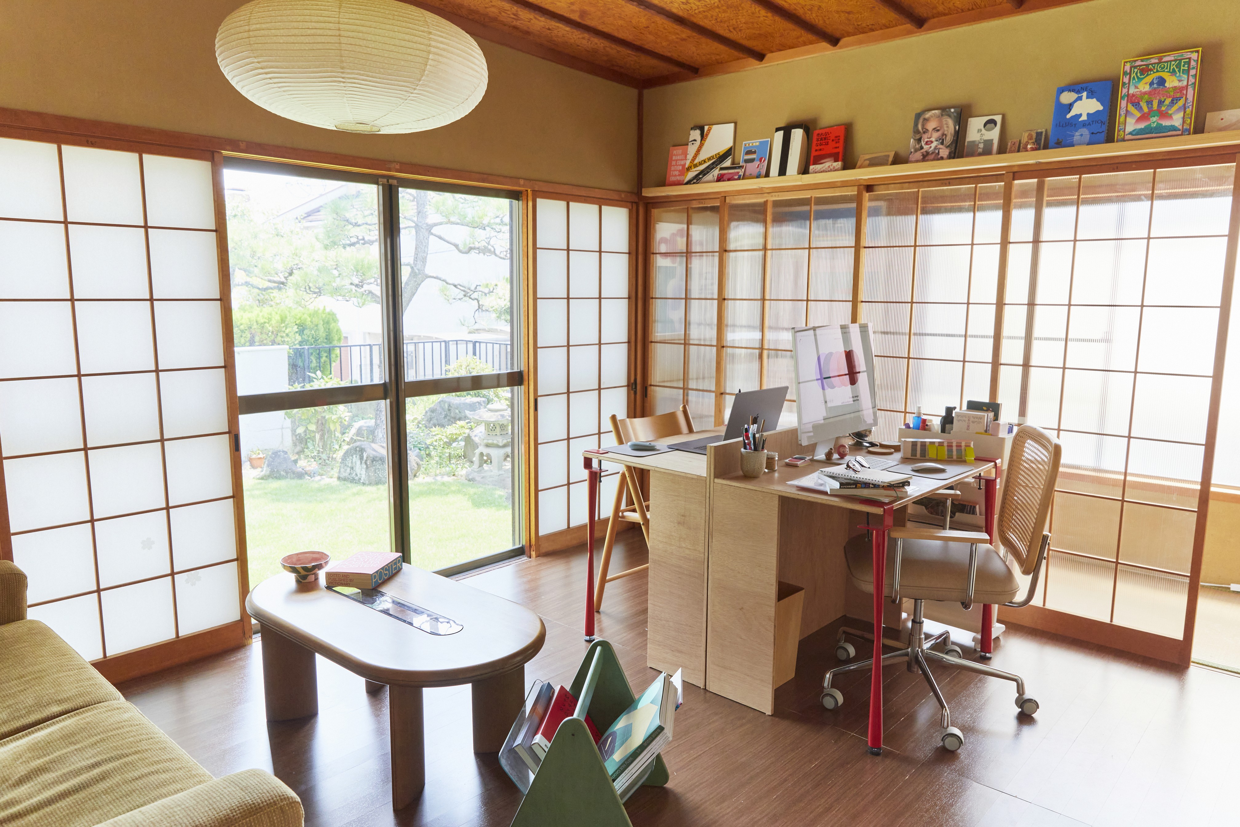 Josephine Grenier’s graphic design studio set inside a Japanese room with shōji doors, natural light and a wooden desk with creative tools.