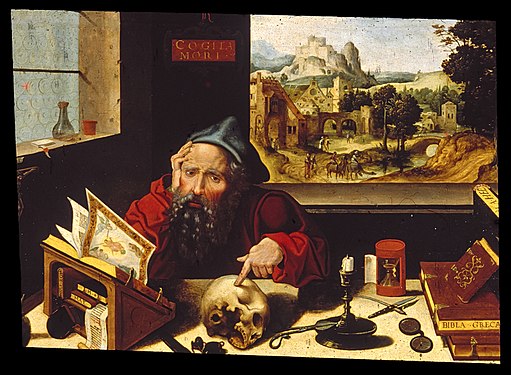 A man with a blue hat sits at a table, surrounded by tools and objects, focused on his work in a warmly lit room.