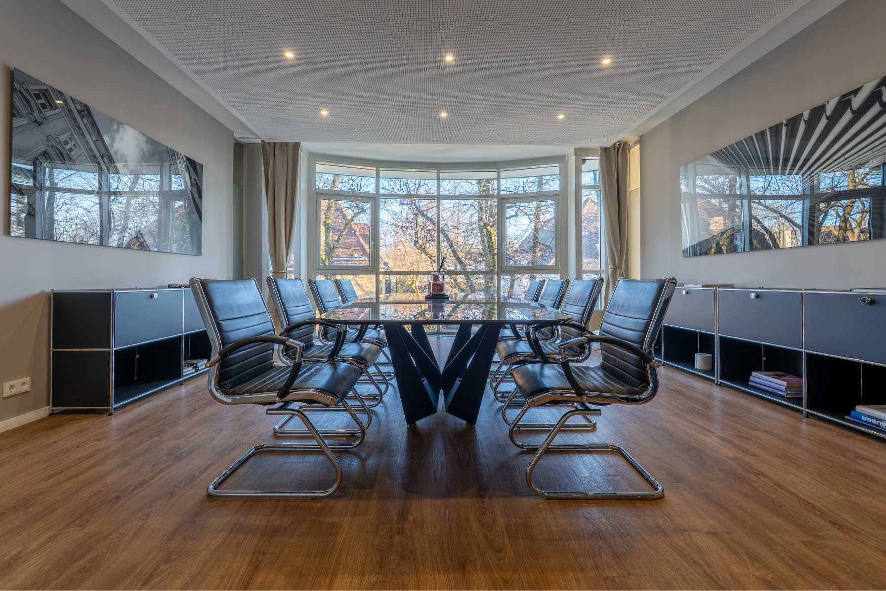 Modern living room with vertical garden, yellow sofas, and stylish coffee tables.