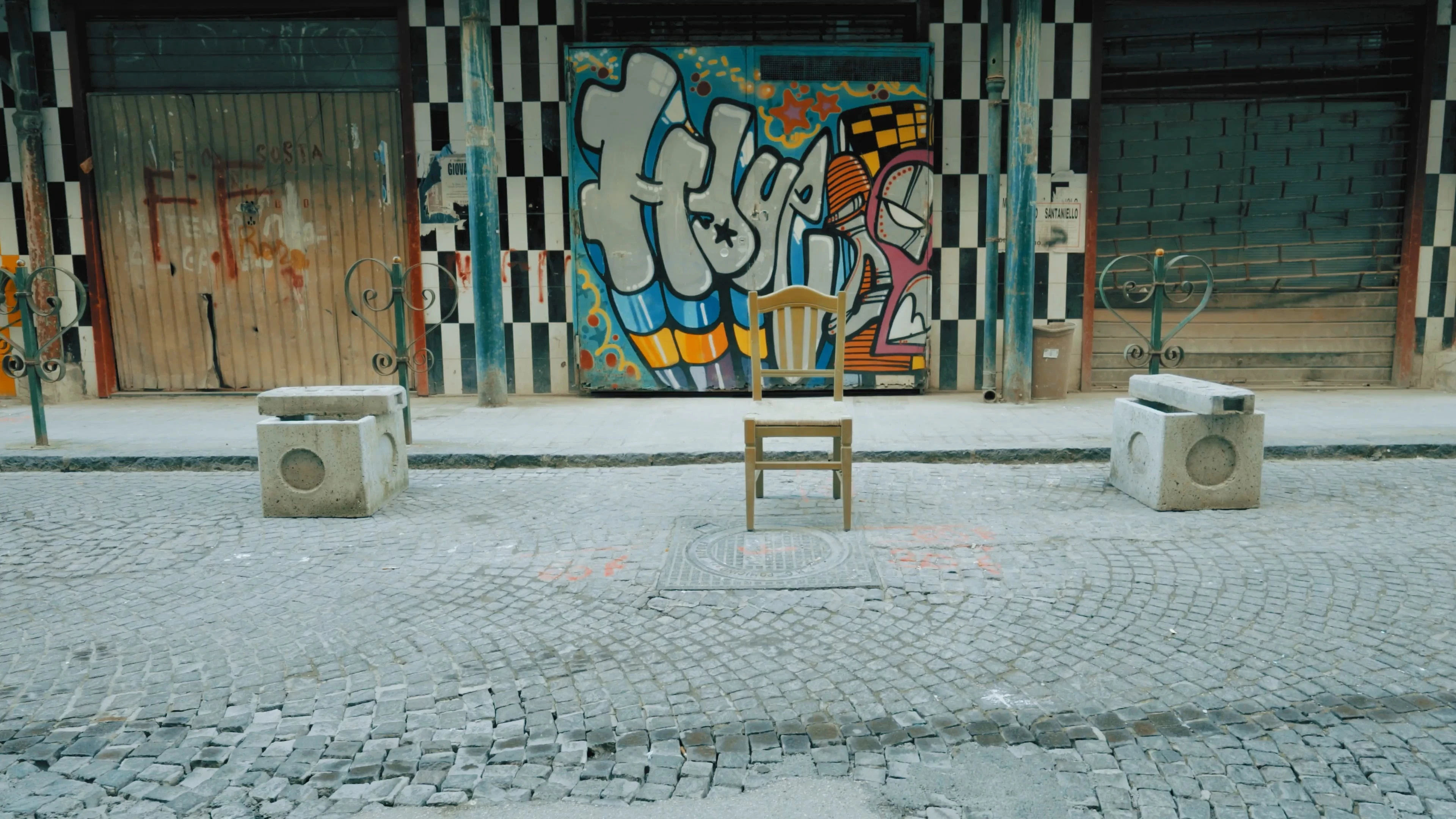 a chair in the middle of an artsy street