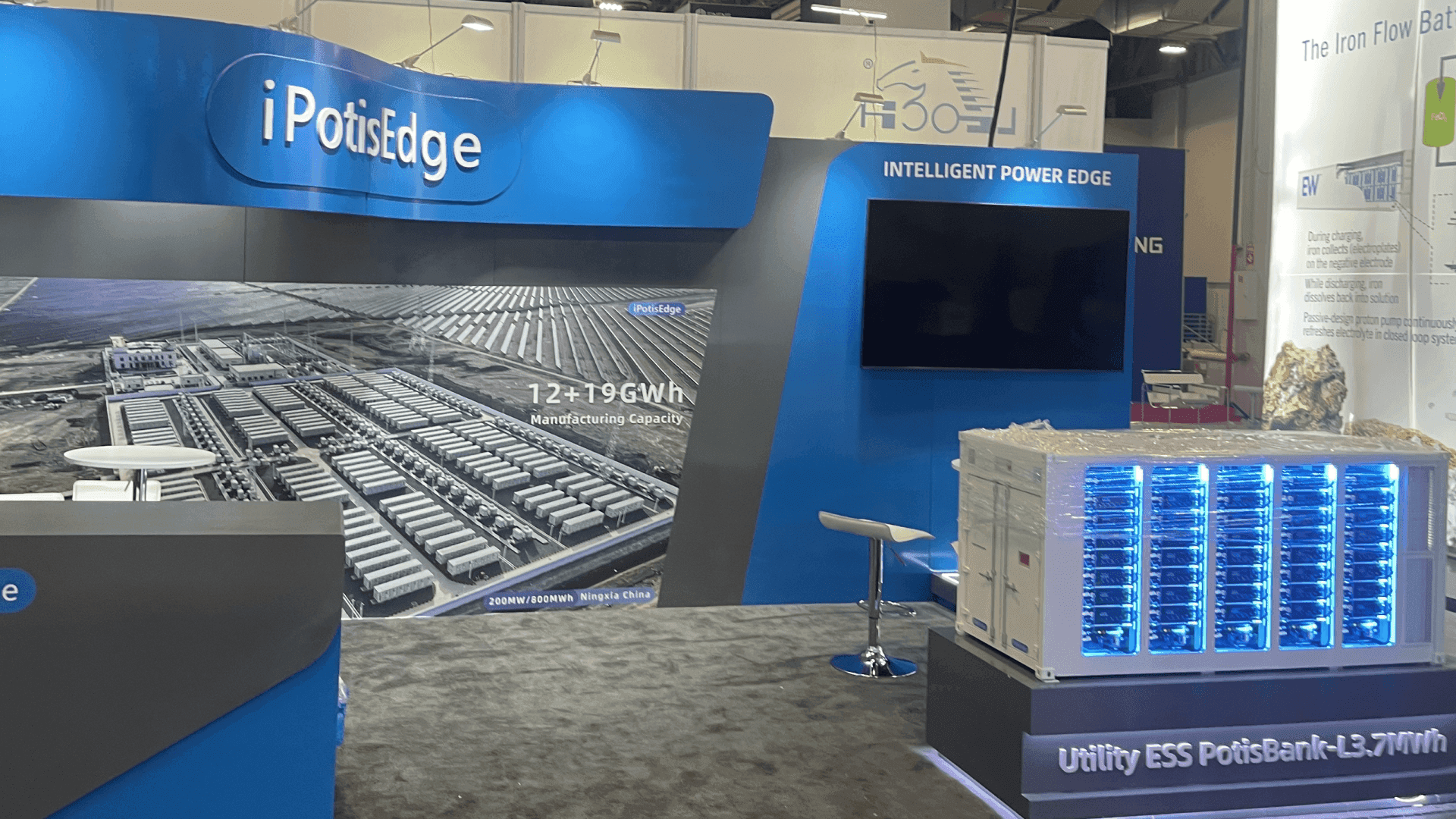 IpstisEdge RE+ 2023 10x20 renewable energy booth in Las Vegas with manufacturing capacity graphic, blue ESS product display, and monitor zone