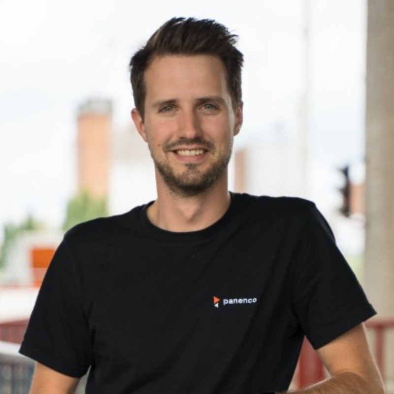 grayscale photography of sitting man wearing suit