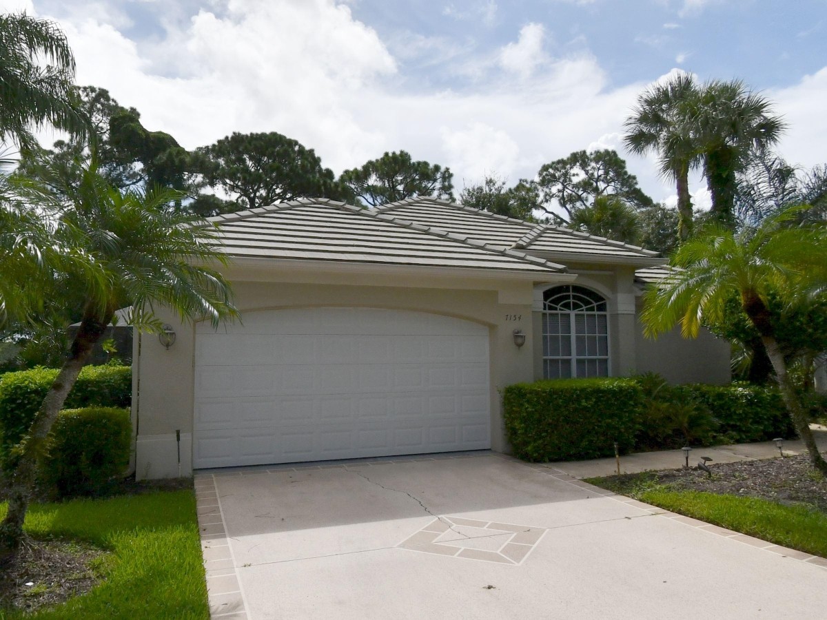 1995 New Roof Construction in Hawks View, PGA Village, Port St Lucie with Entegra Flat Broomswept Tile in Natural Gray