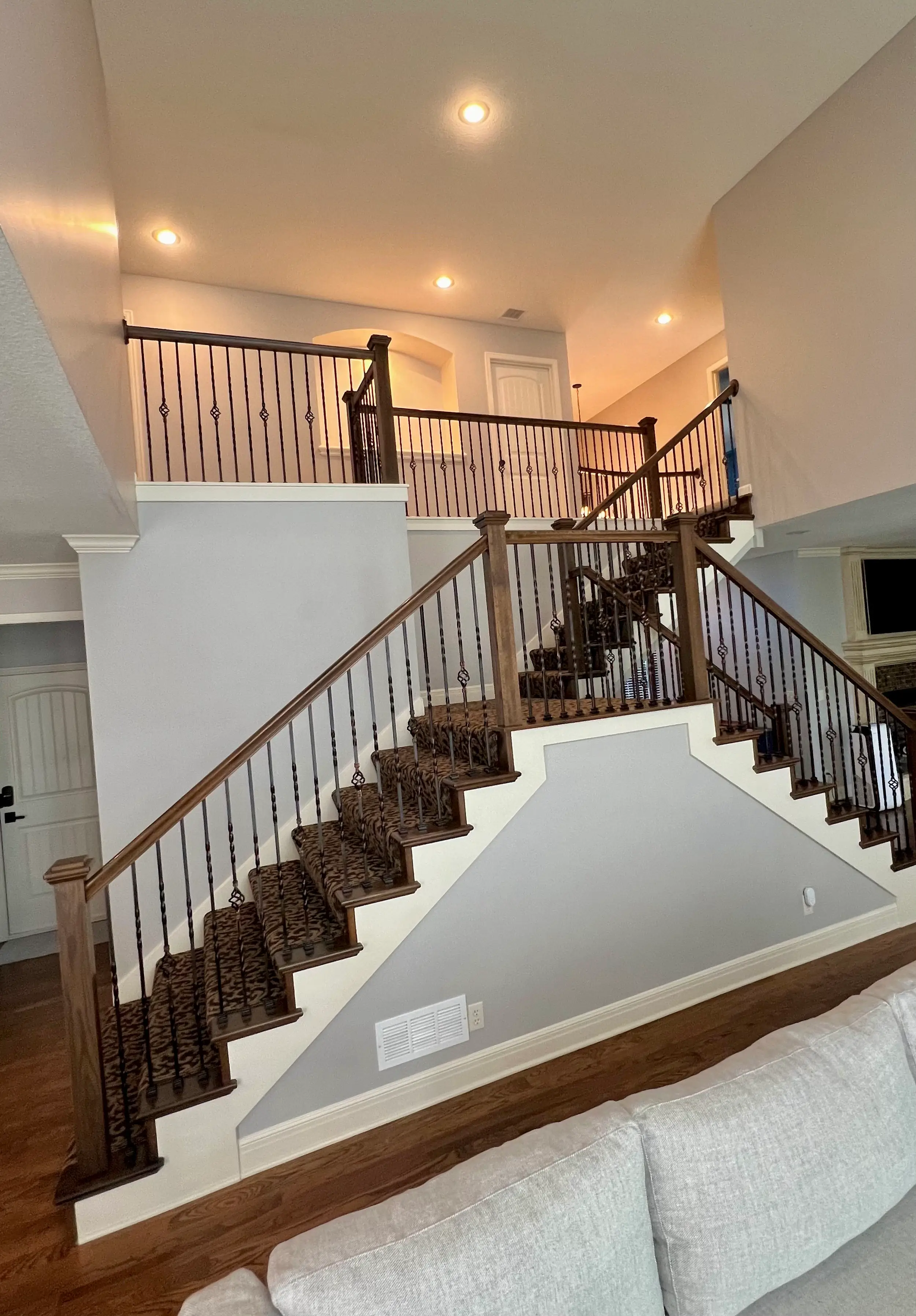 An image of newly painted stairs in light grey with white trim.