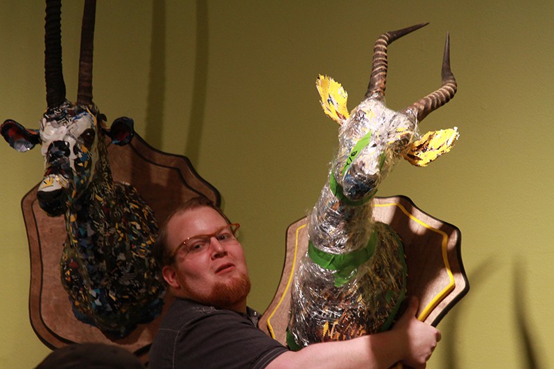 a man taking down deer head