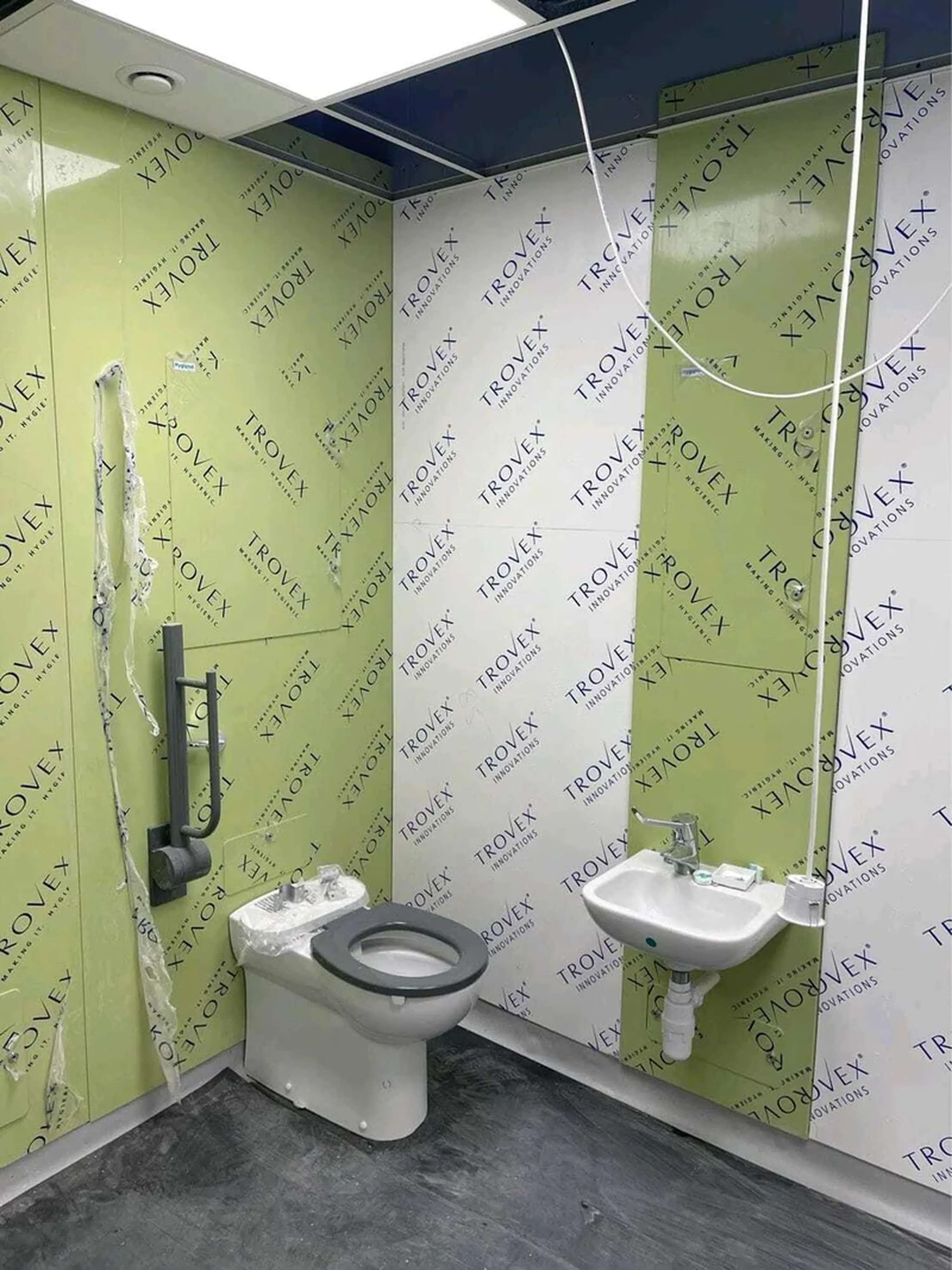 Hygipod IPS being insalled with a DOC M pack and clincial wash hand basin