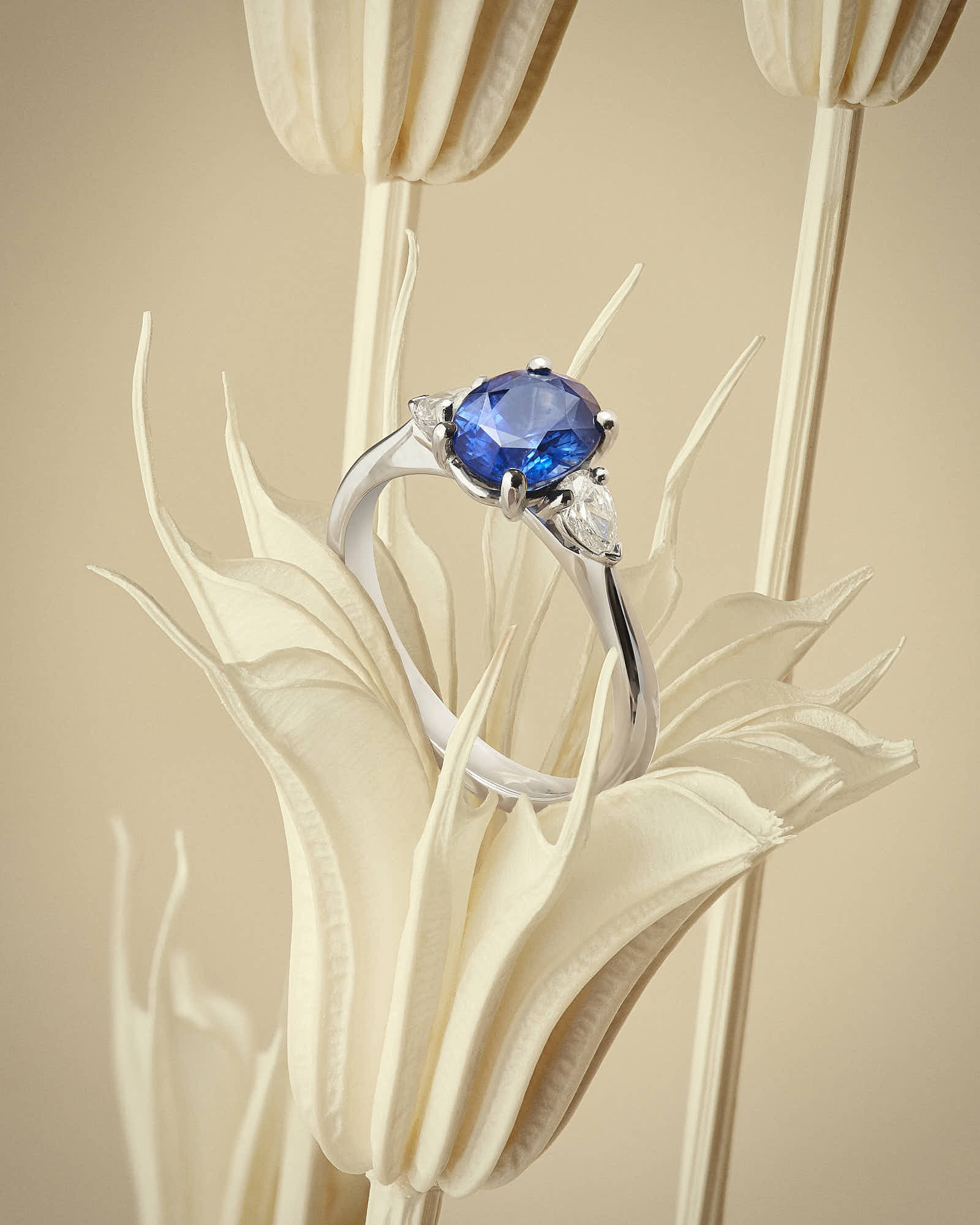 Elegant blue gemstone ring with diamonds on delicate flower background