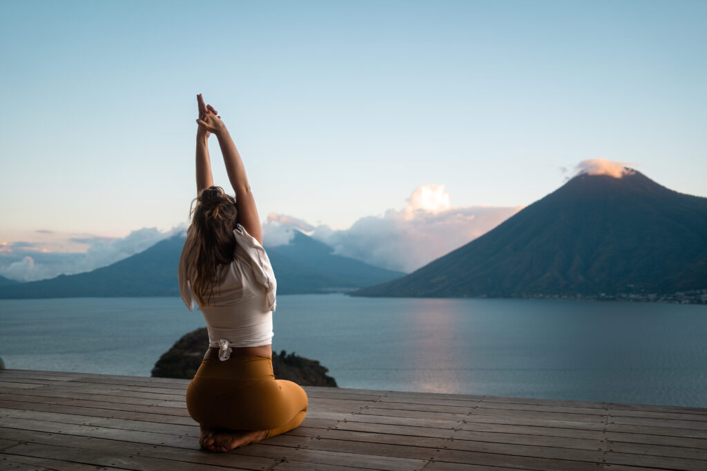 woman doing yoga by the lake