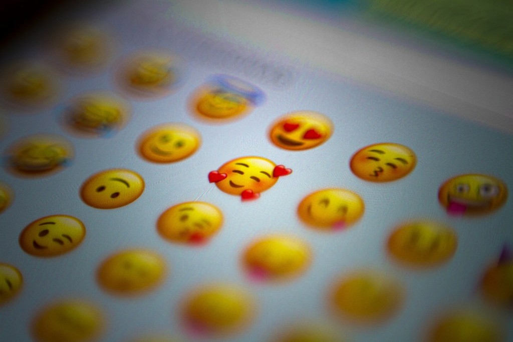 A photo of a phone screen showing a selection of emoji faces