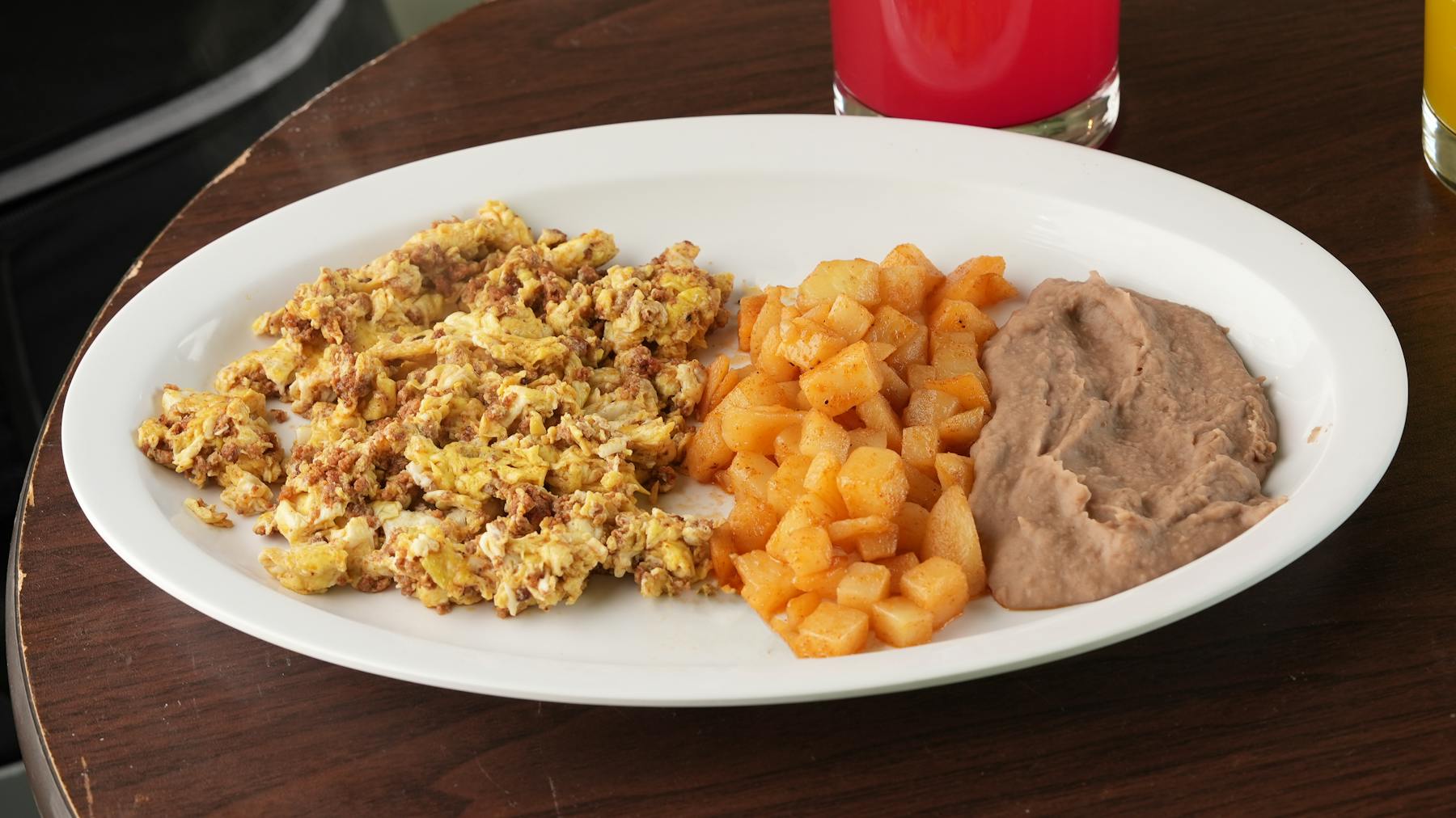 wo scrambled eggs perfectly blended with spicy chorizo, accompanied by traditional beans and warm corn tortillas.