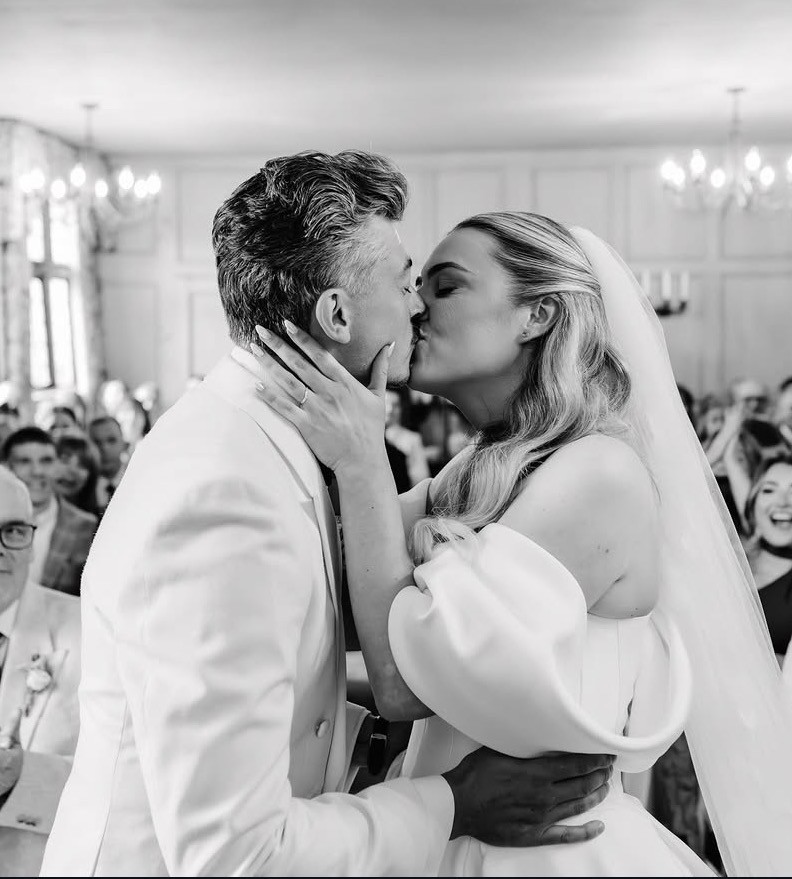Newlyweds sharing their first kiss