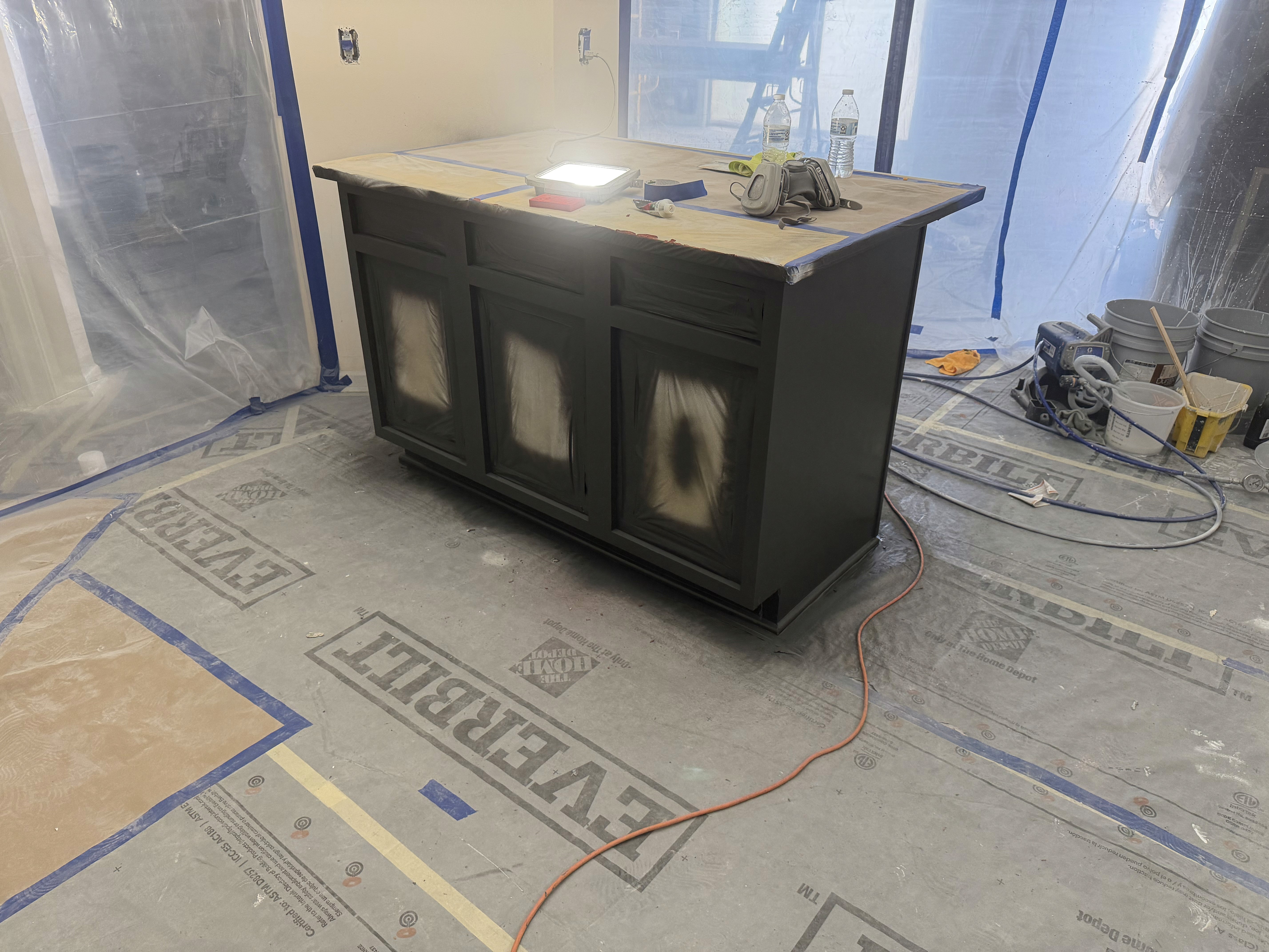 Professional spray application inside a protected kitchen