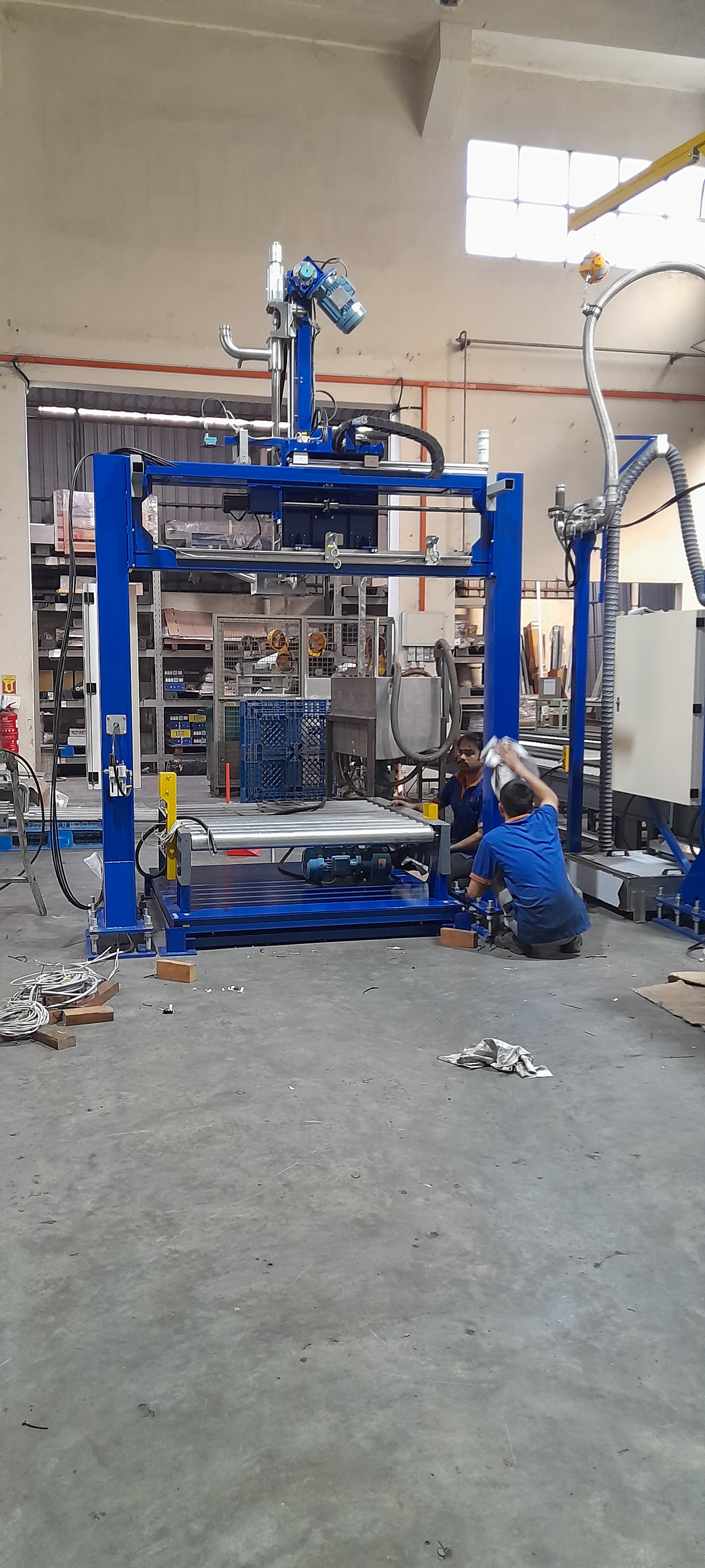 A frontal view of the complete IBC filling machine, with two IBC containers in the background.