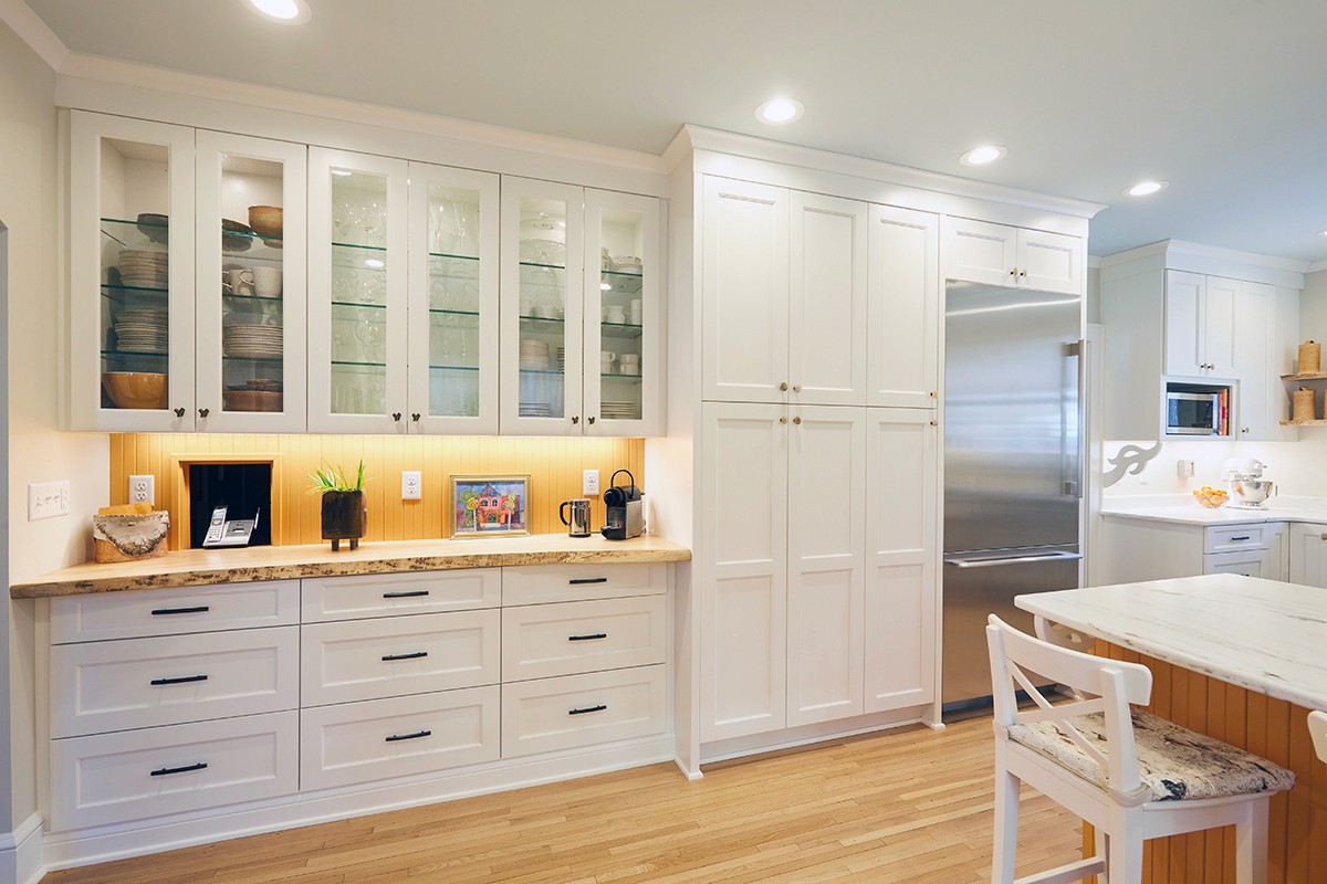 Glass-front display cabinetry and built-in refrigerator in the Linden Hills kitchen, Minneapolis