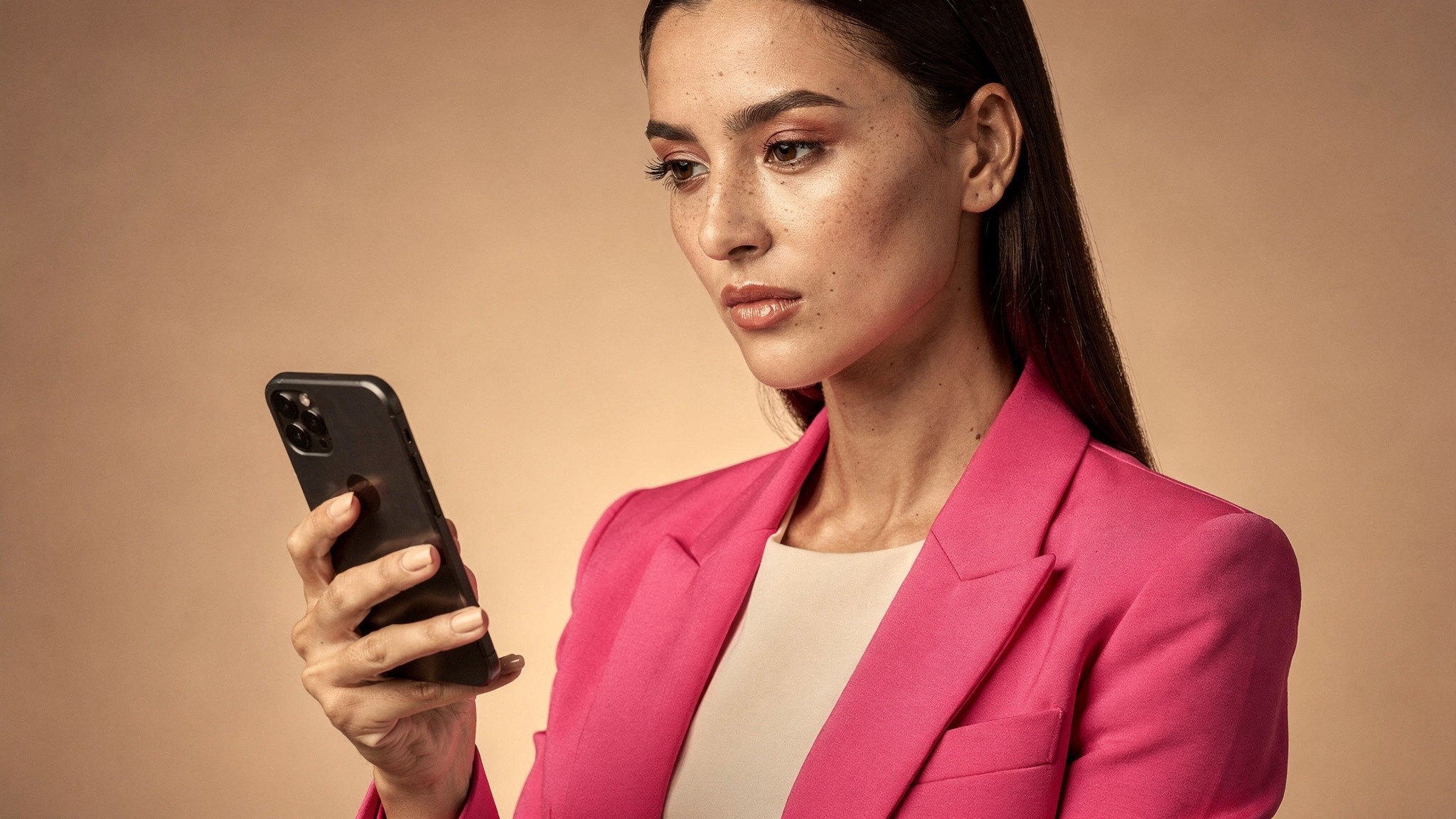 Creator reviewing her phone analytics with a calm focused expression