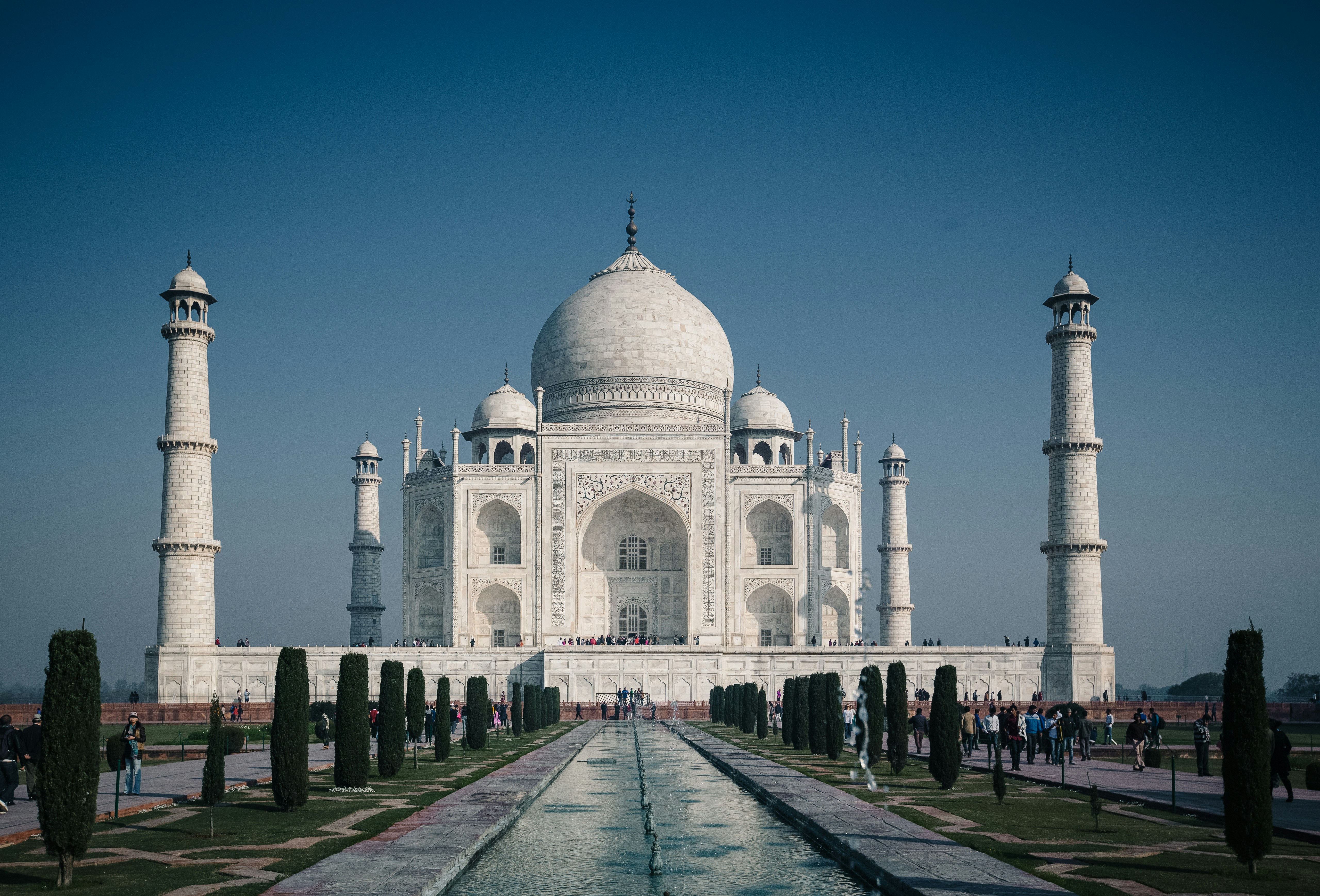 a large white building with a fountain in front of it