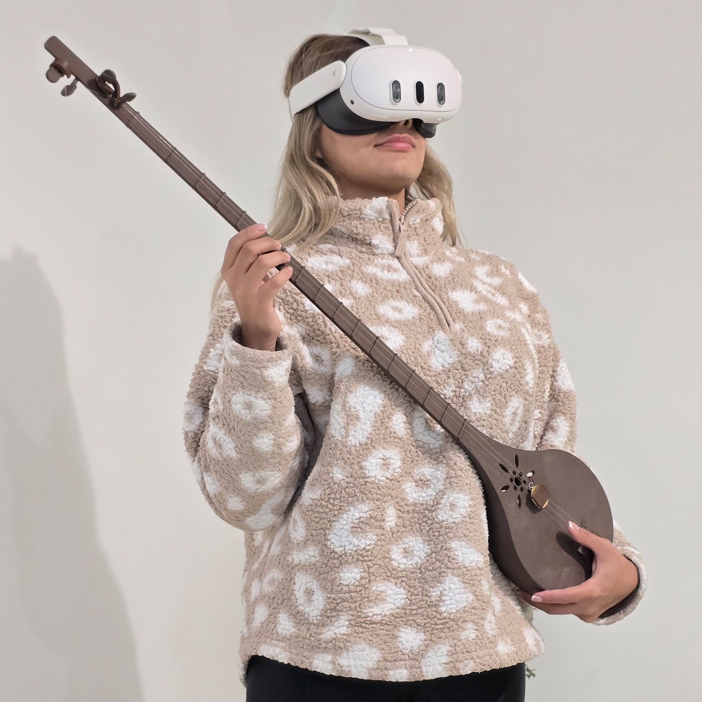 User interacting with the VR experience using a physical Setar instrument and VR headset