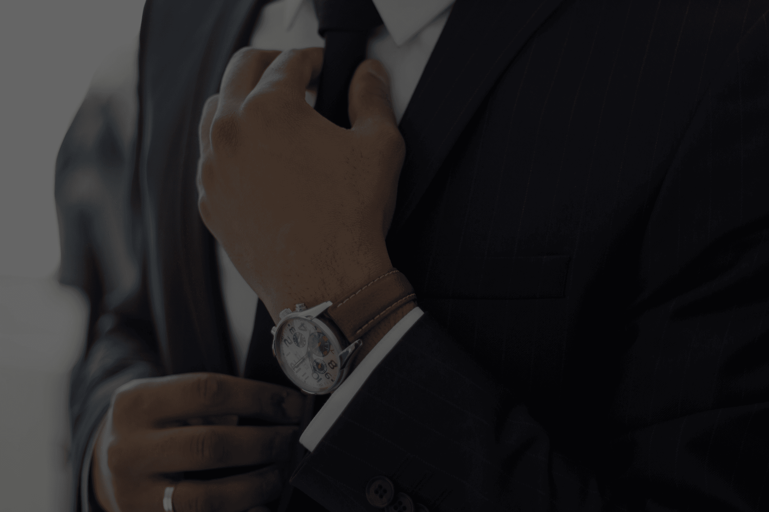 man wearing watch with black suit