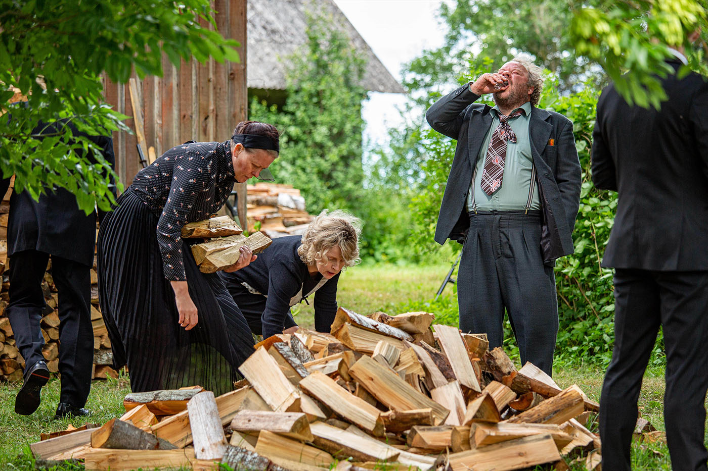 Scene from Estonian Funeral, showing a man drinking during a chaotic family gathering. A dark comedy about love, identity, and clashing generations in modern and traditional Estonia.