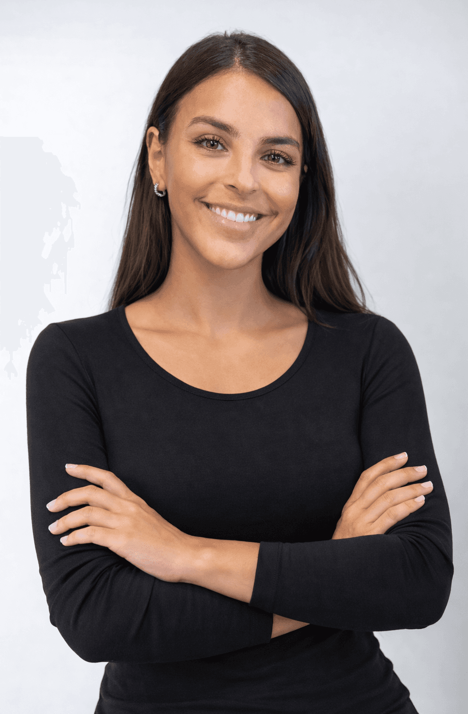 Portrait of a person in a pink sweater against a light background