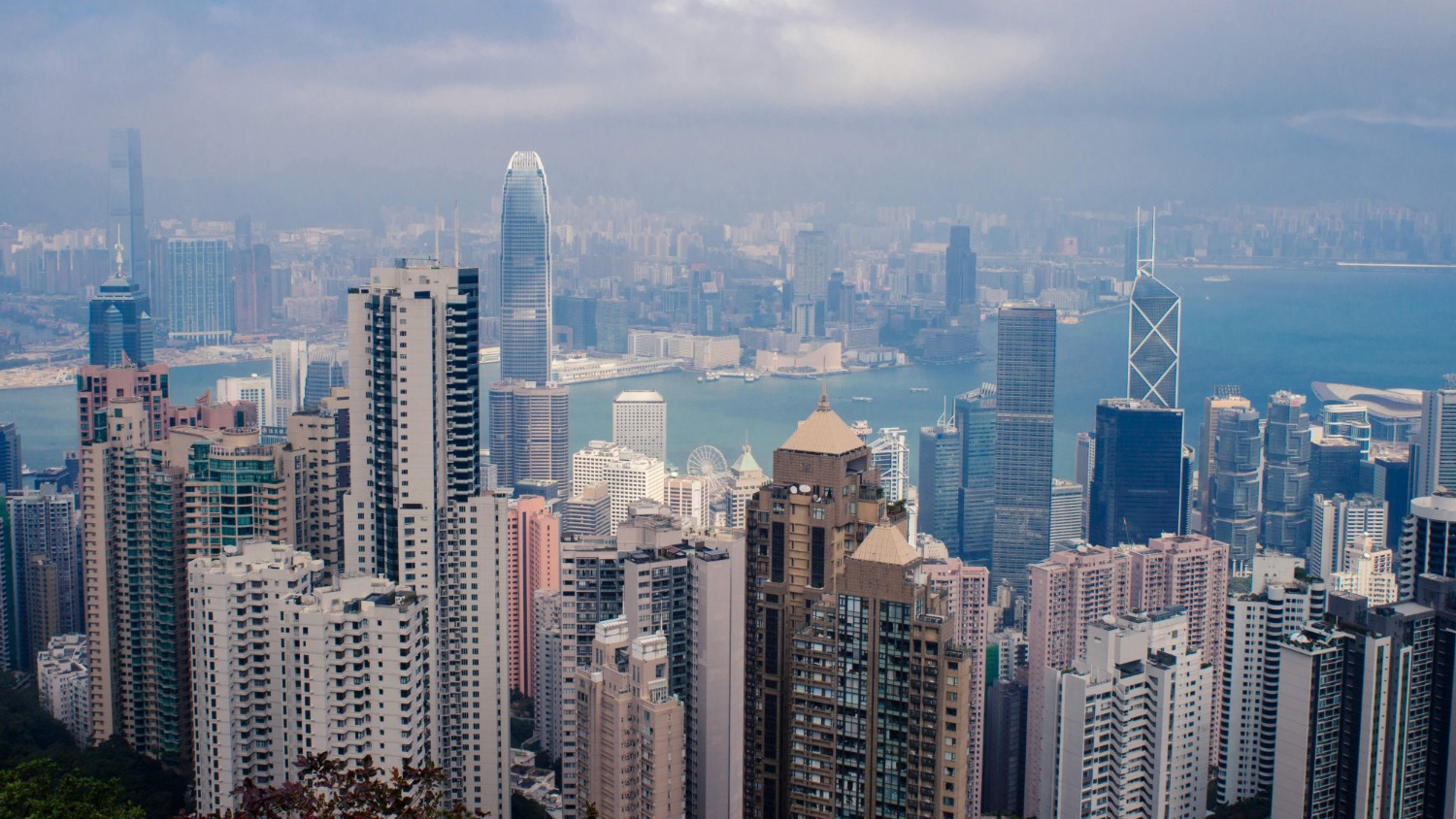 香港中環及金鐘商業區摩天大樓景觀，展示高密度建築群與企業專業風險管理保障環境。