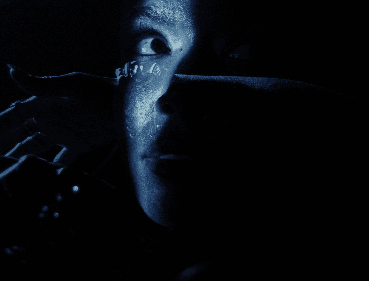 Moody close-up with blue shimmer, from “A Baby Girl Named Heaven” by Sam Austins, post-production by The Machine Shop