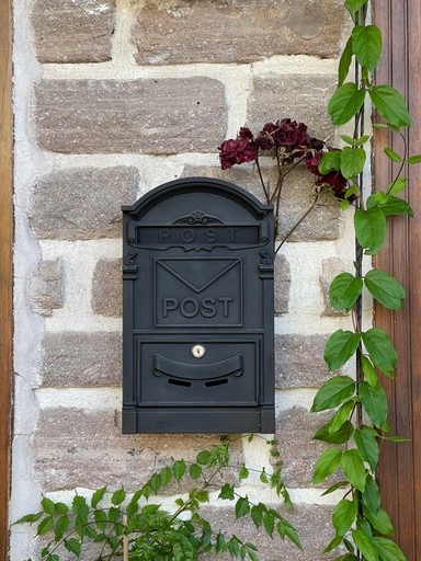 red mail box on road during daytime
