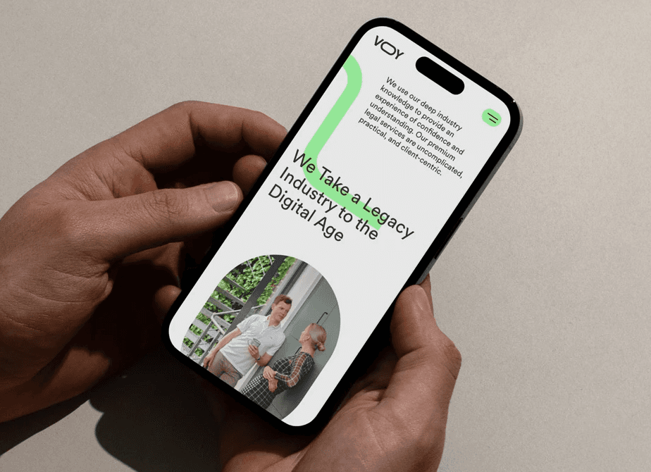 Hands holding a phone viewing website design for VOY law firm.