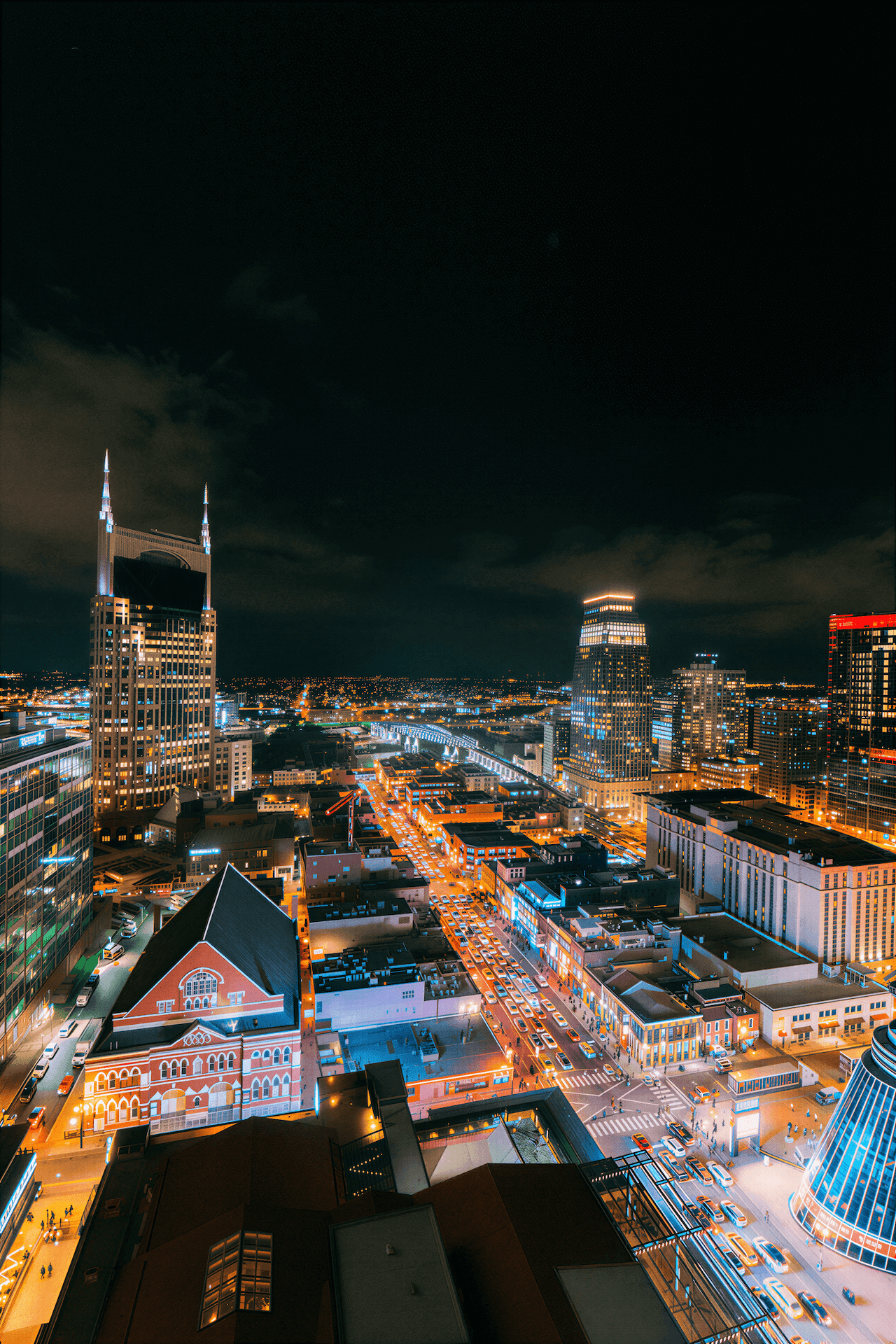 Wide Angle Shot from a Skyscraper Balcony of an Illuminated Broadway in Downtown Nashville on a Cloudy Night