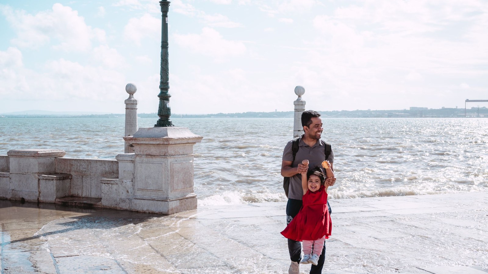 Father and daughter enjoying the coast near Lisbon