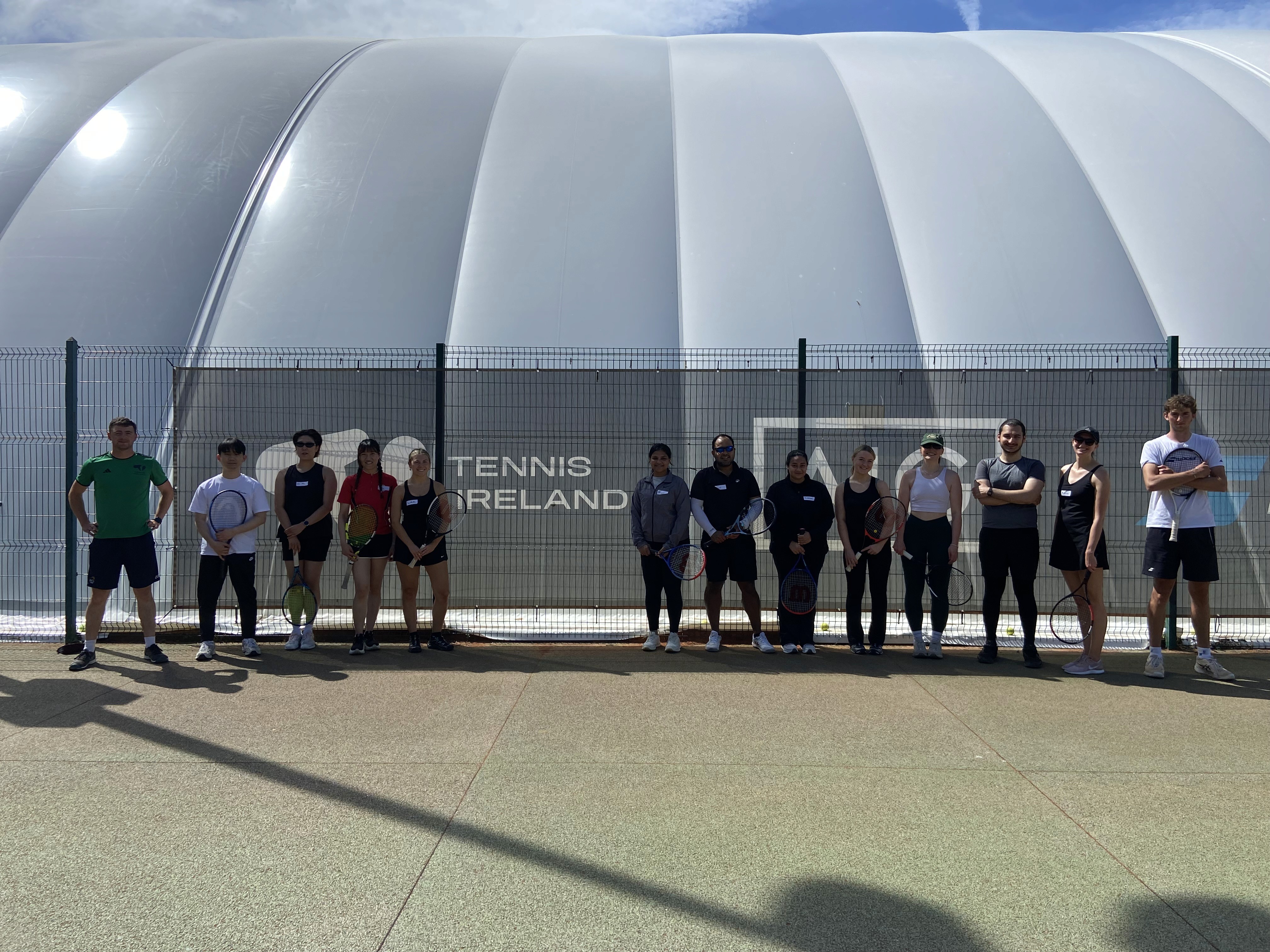 Corporate tennis session participants